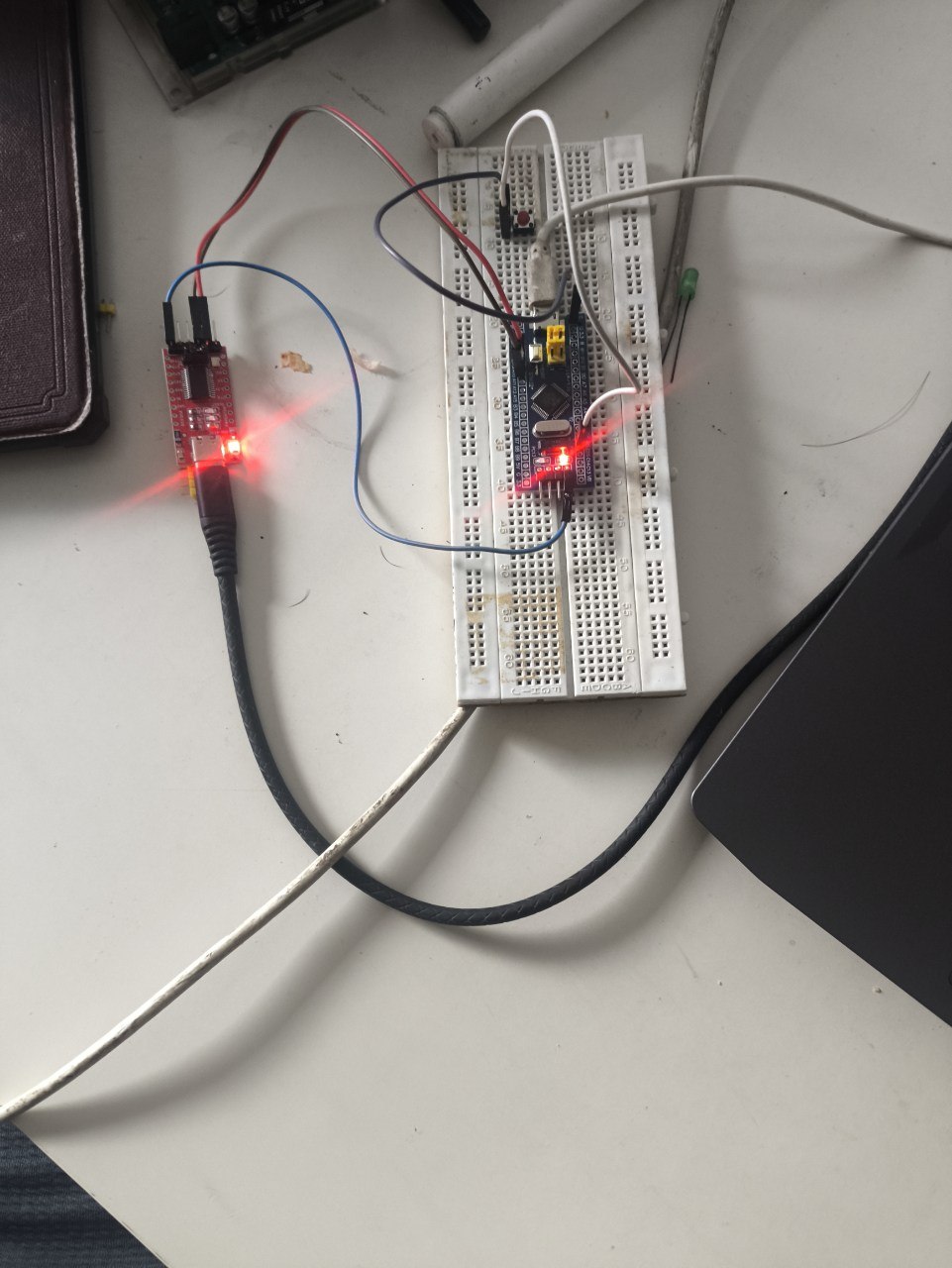 The button wired on the breadboard, resting, LED off