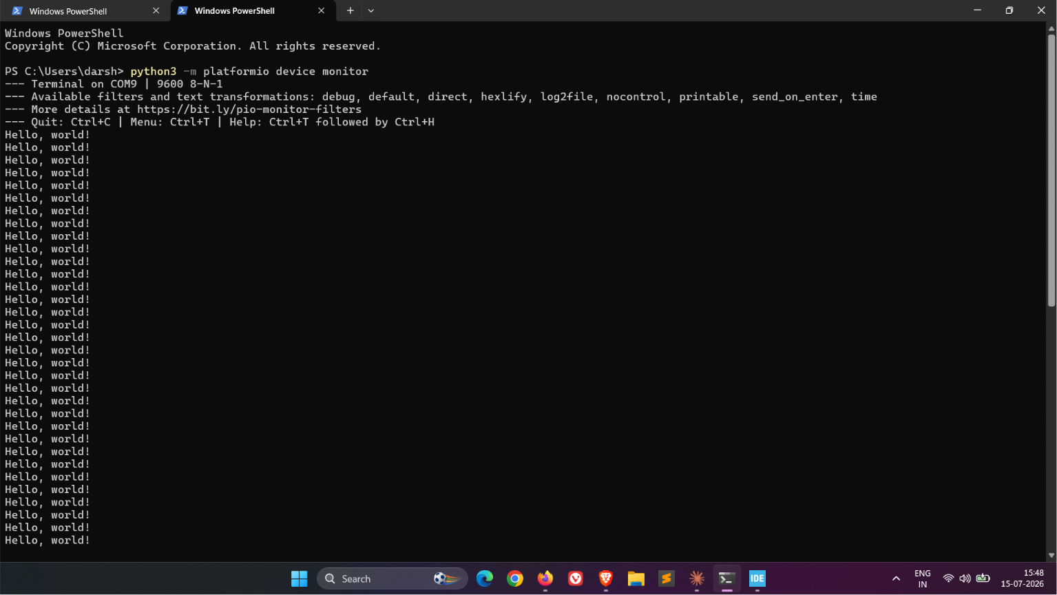 A PowerShell terminal running platformio device monitor on COM9 at 9600 baud, printing repeated Hello, world! lines